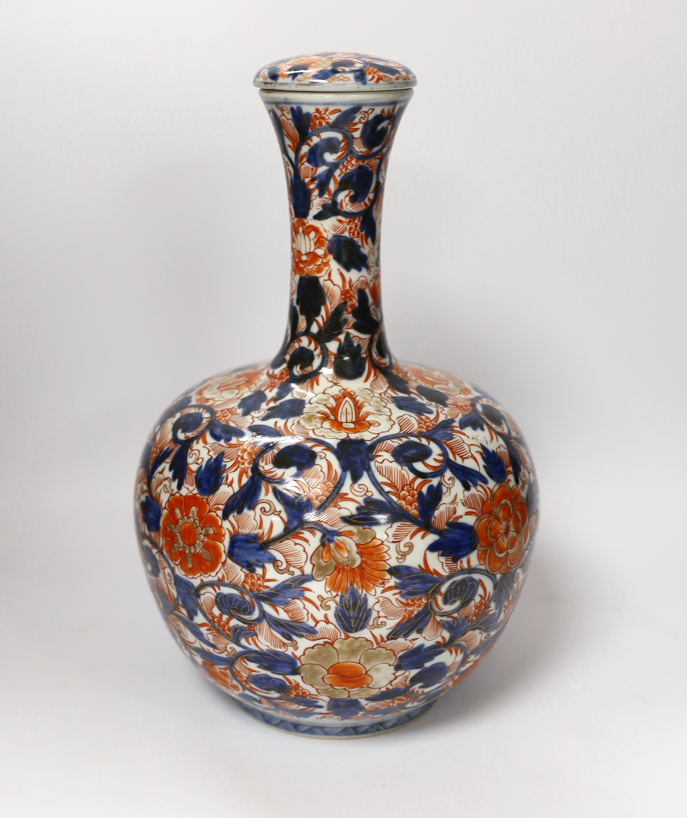 A pair of Chinese blue and white crackleware vases and covers and an Imari vase and cover, largest 31cm high